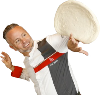 Tony Gemignani spinning pizza dough in his USA team jersey